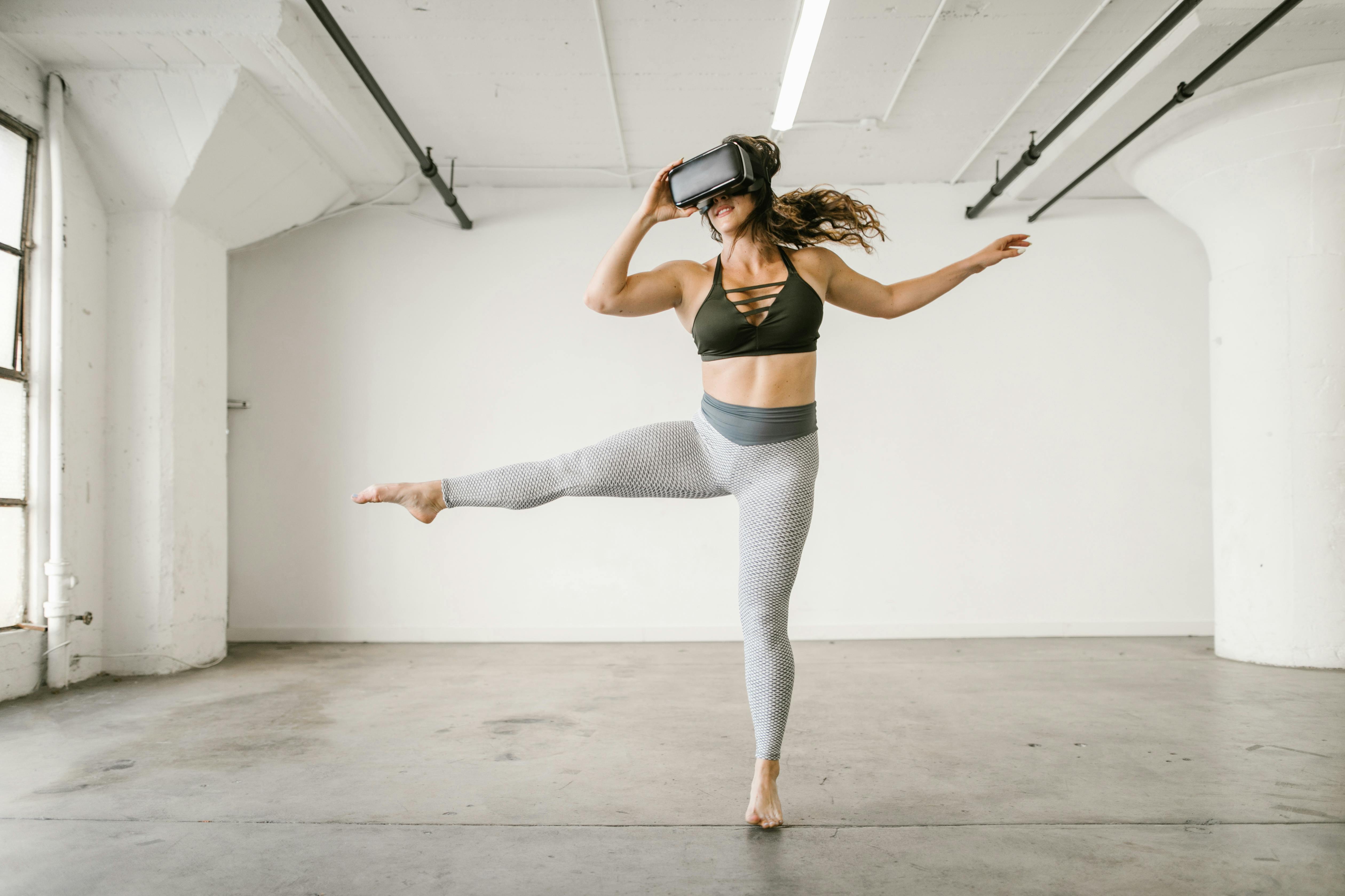 woman dancing while wearing virtual reality glasses