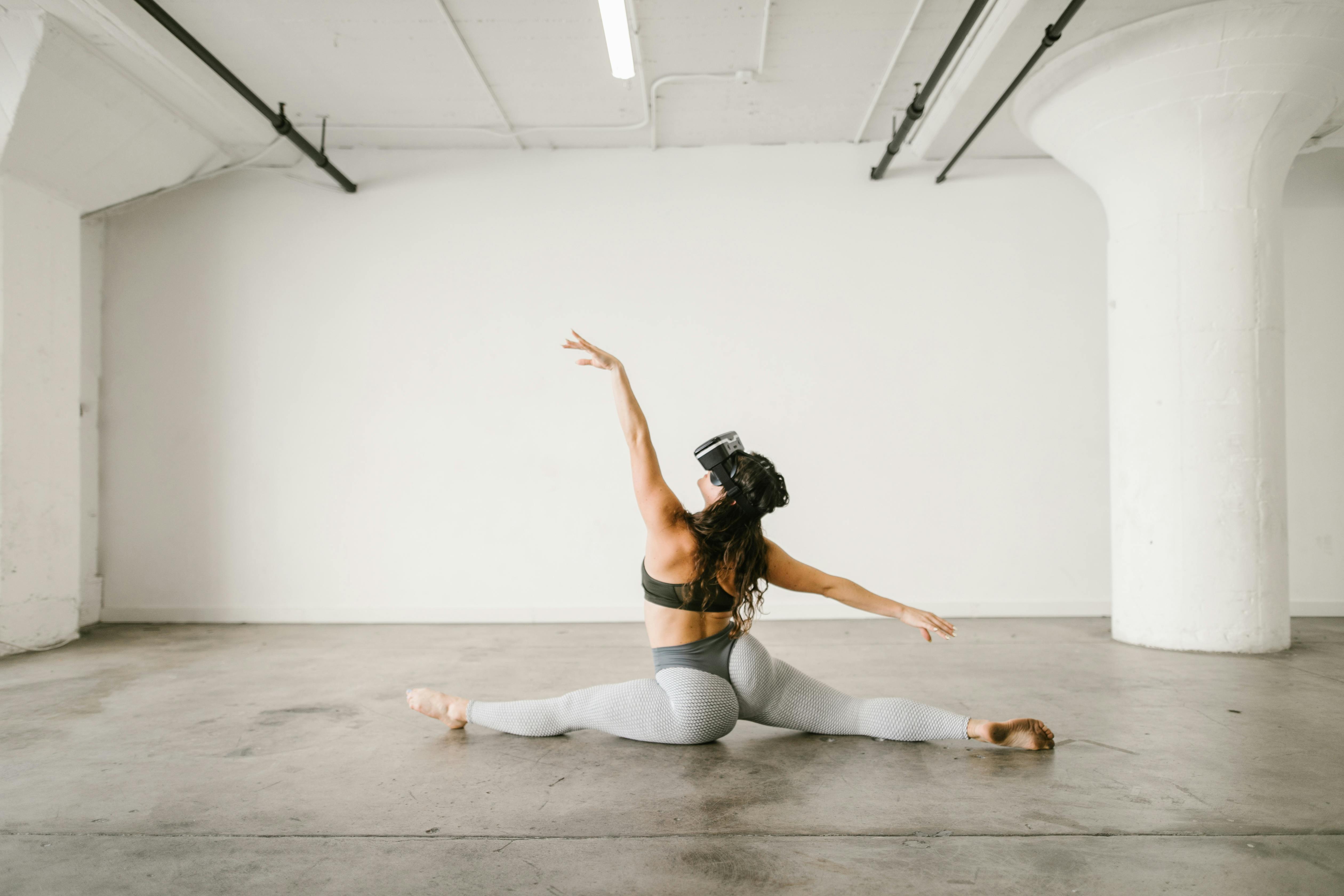 woman dancing while wearing virtual reality glasses