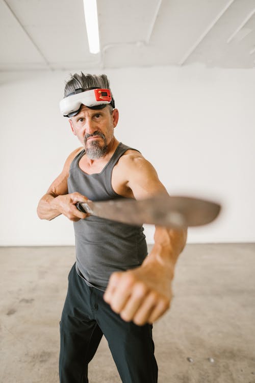 Free Selective Focus Photo of Man holding a Sword  Stock Photo