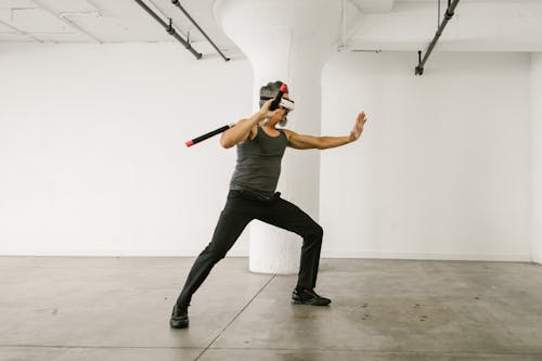 Man using Nunchaku while wearing Virtual Reality Glasses