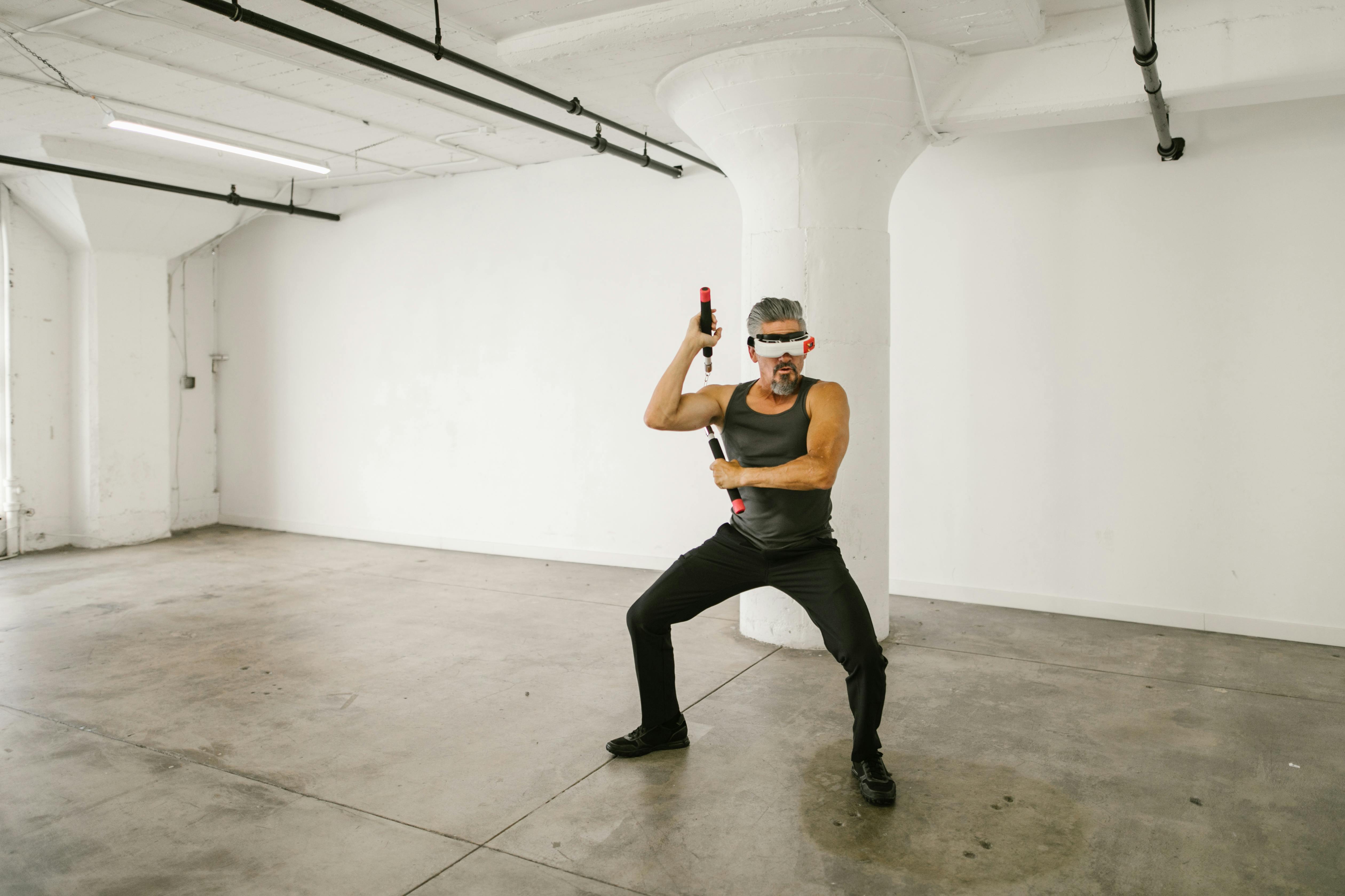 man using nunchaku while wearing virtual reality glasses