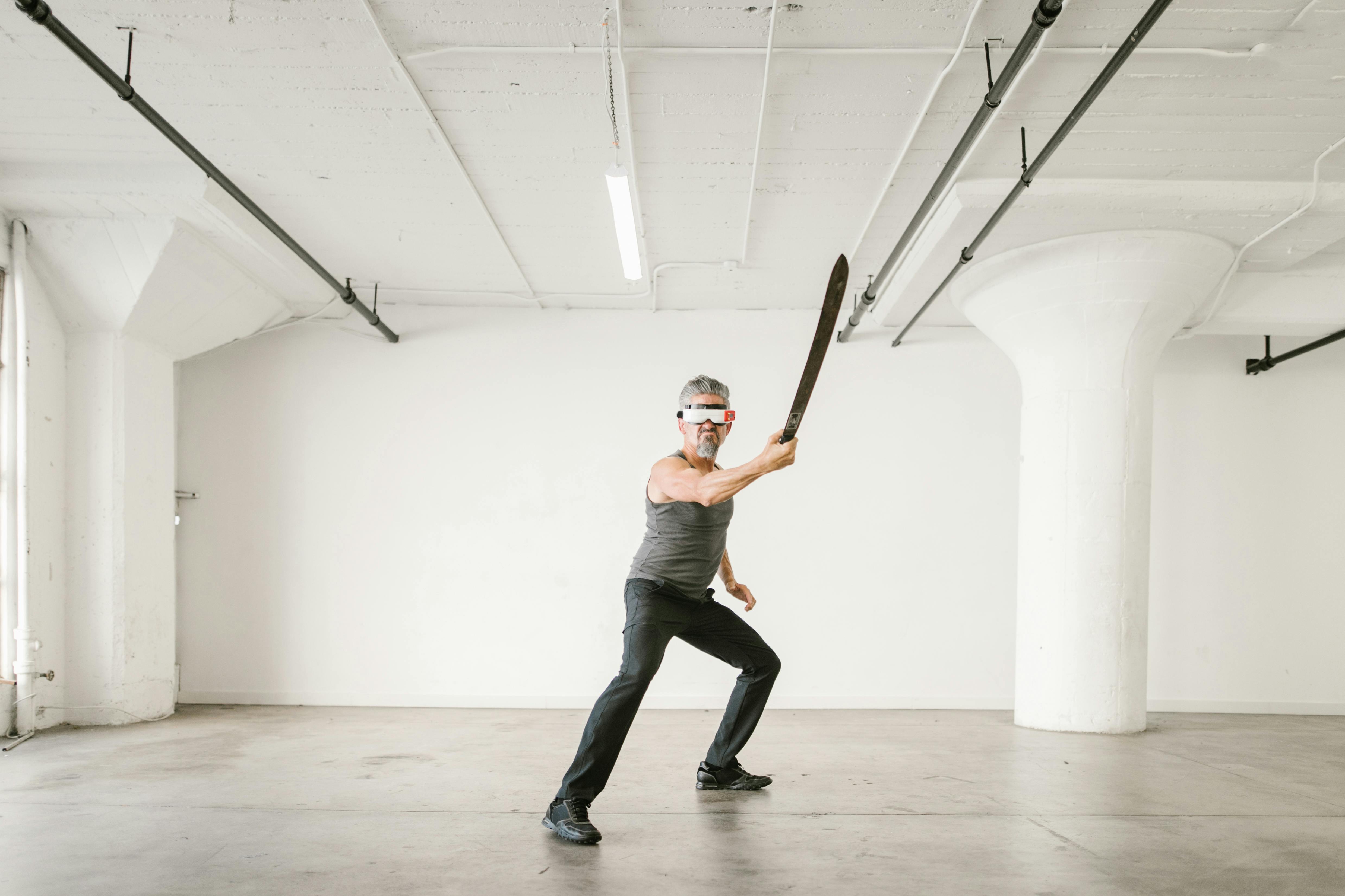 man using a sword while wearing virtual reality glasses