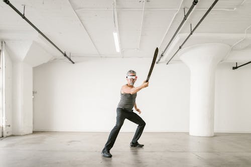 Man using a Sword while wearing Virtual Reality Glasses