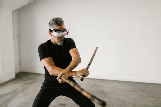 Adult man using virtual reality headset to practice martial arts indoors.