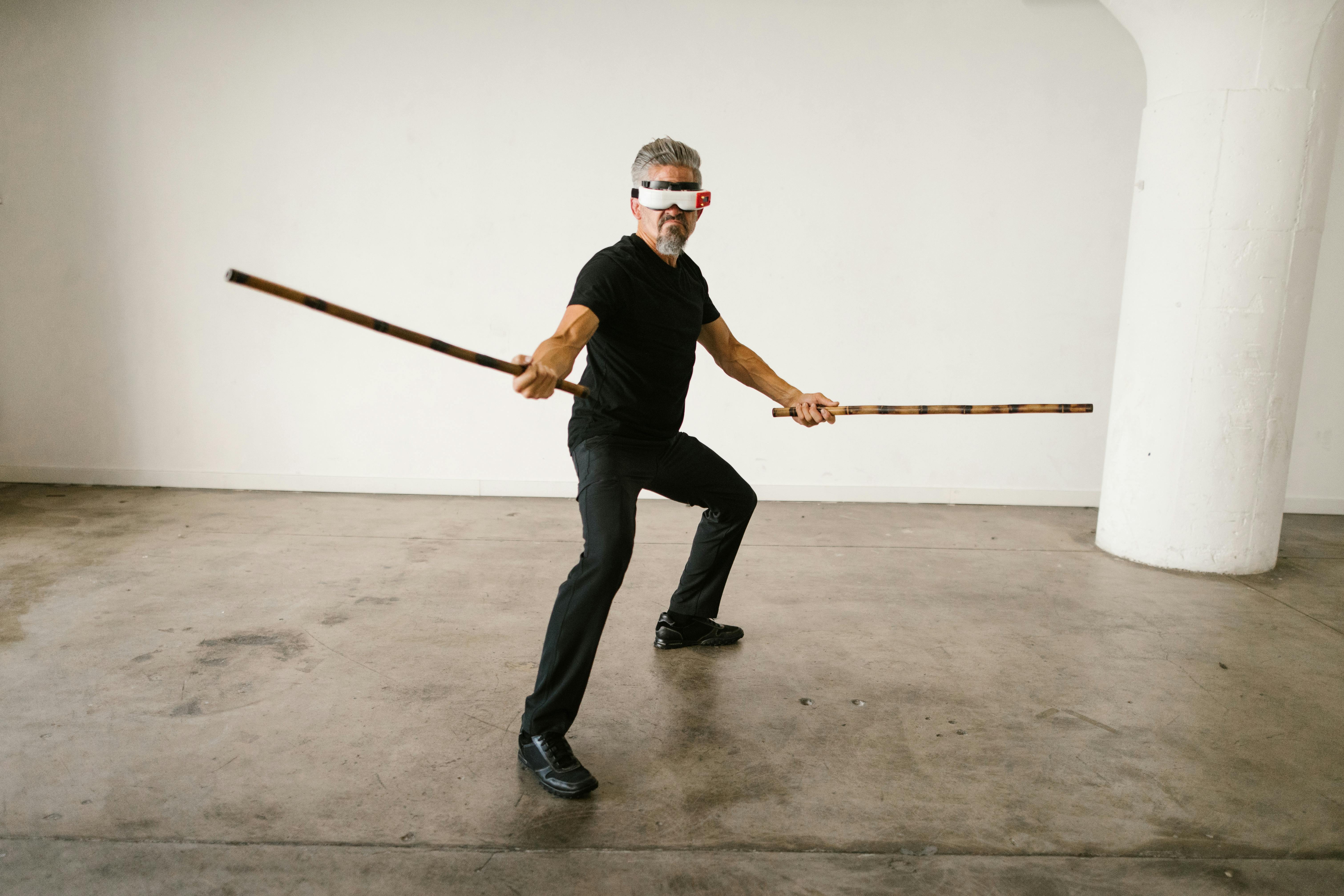 man using an arnis while wearing virtual reality glasses