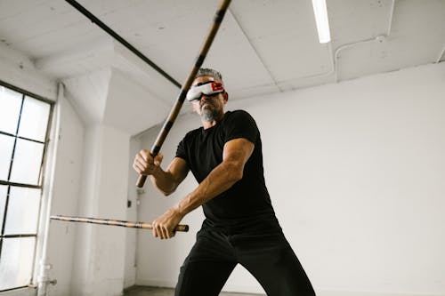 Free Man using an Arnis while wearing Virtual Reality Glasses Stock Photo