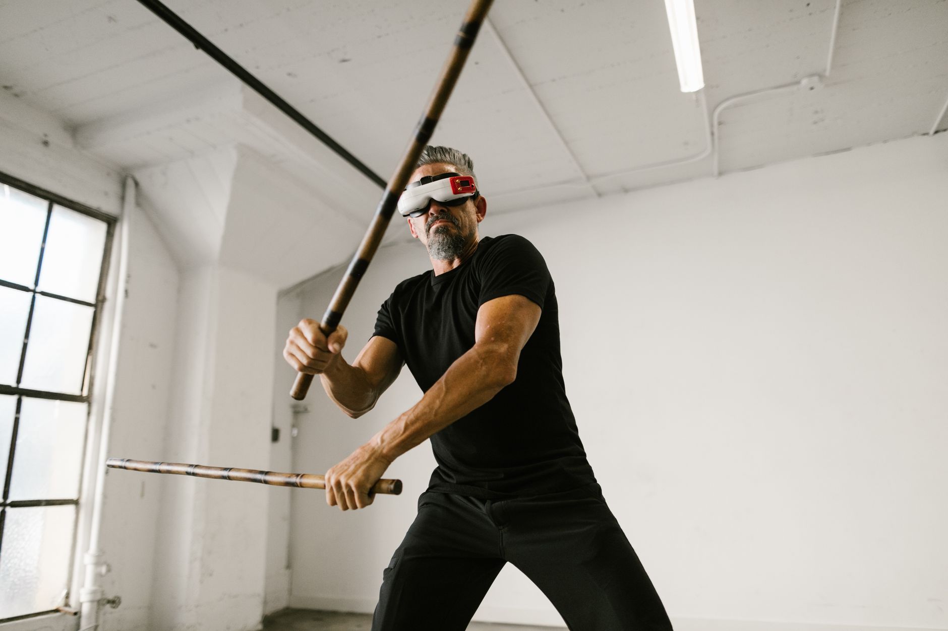 https://www.pexels.com/photo/man-using-an-arnis-while-wearing-virtual-reality-glasses-8097939/