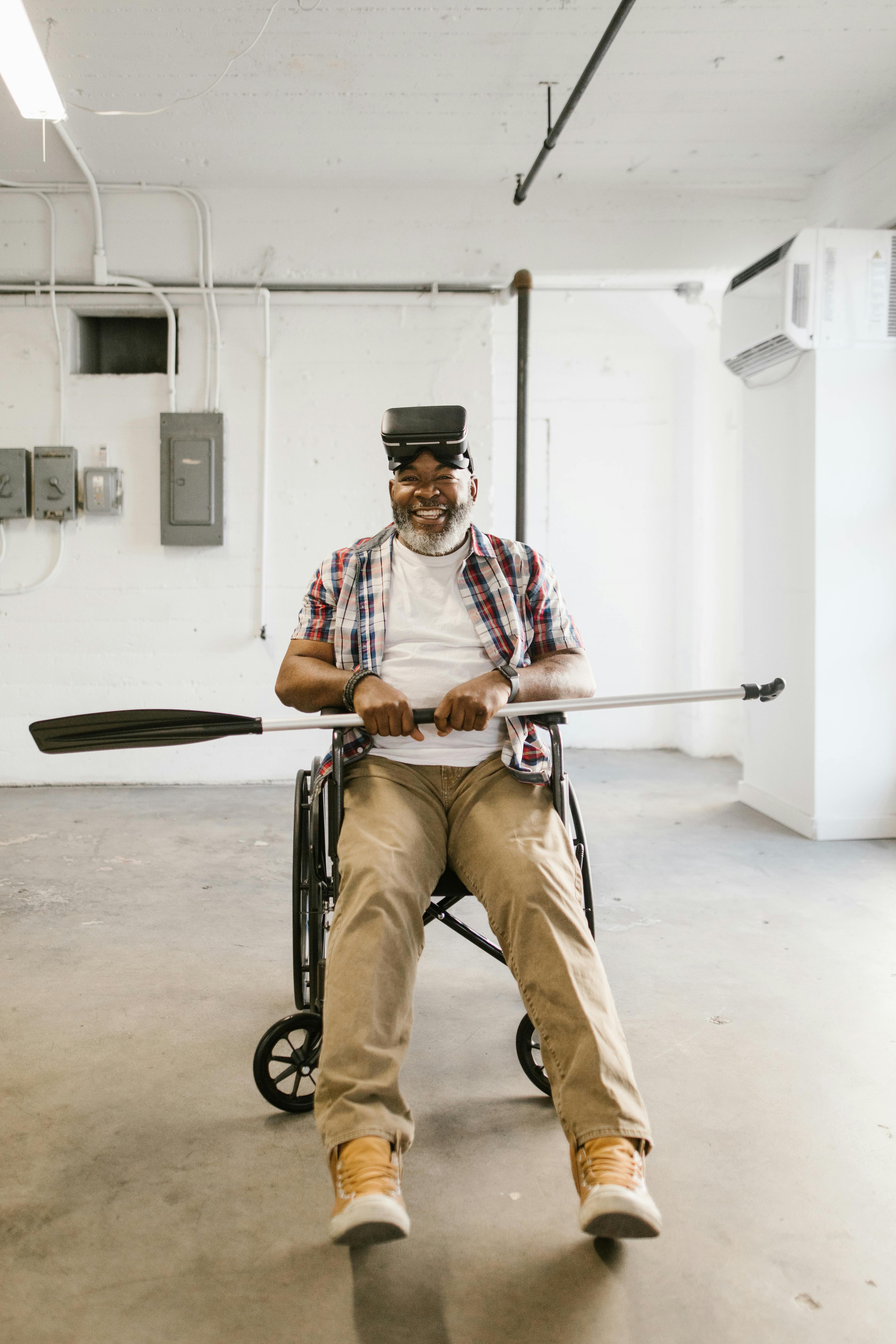 man sitting on a wheelchair while wearing virtual reality glasses