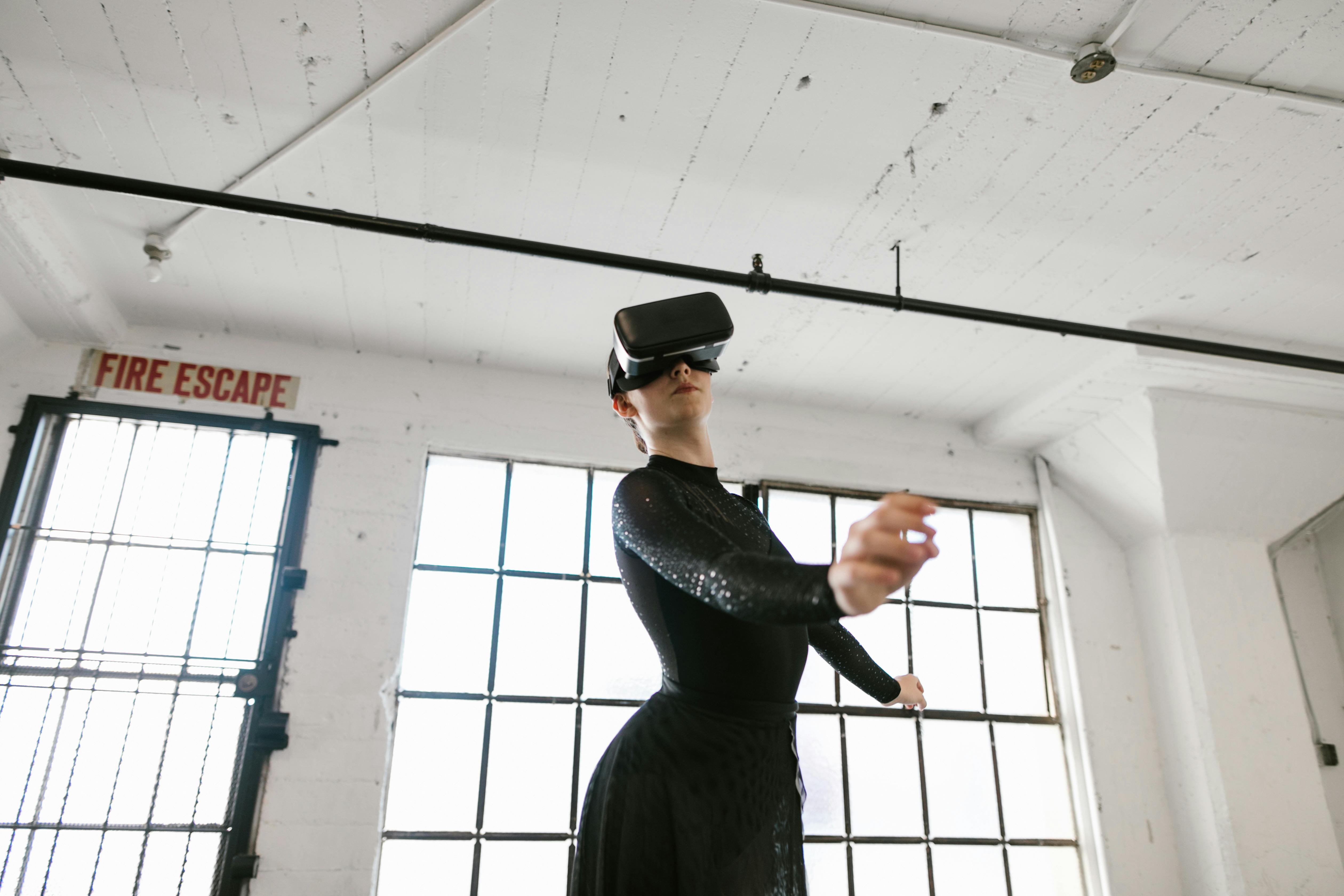 woman dancing while wearing virtual reality glasses