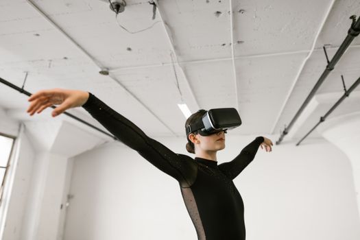 A woman engaging in ballet training using virtual reality indoors.