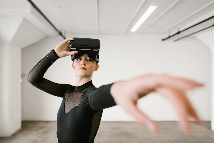 A Woman In Black Leotard With VR Goggles