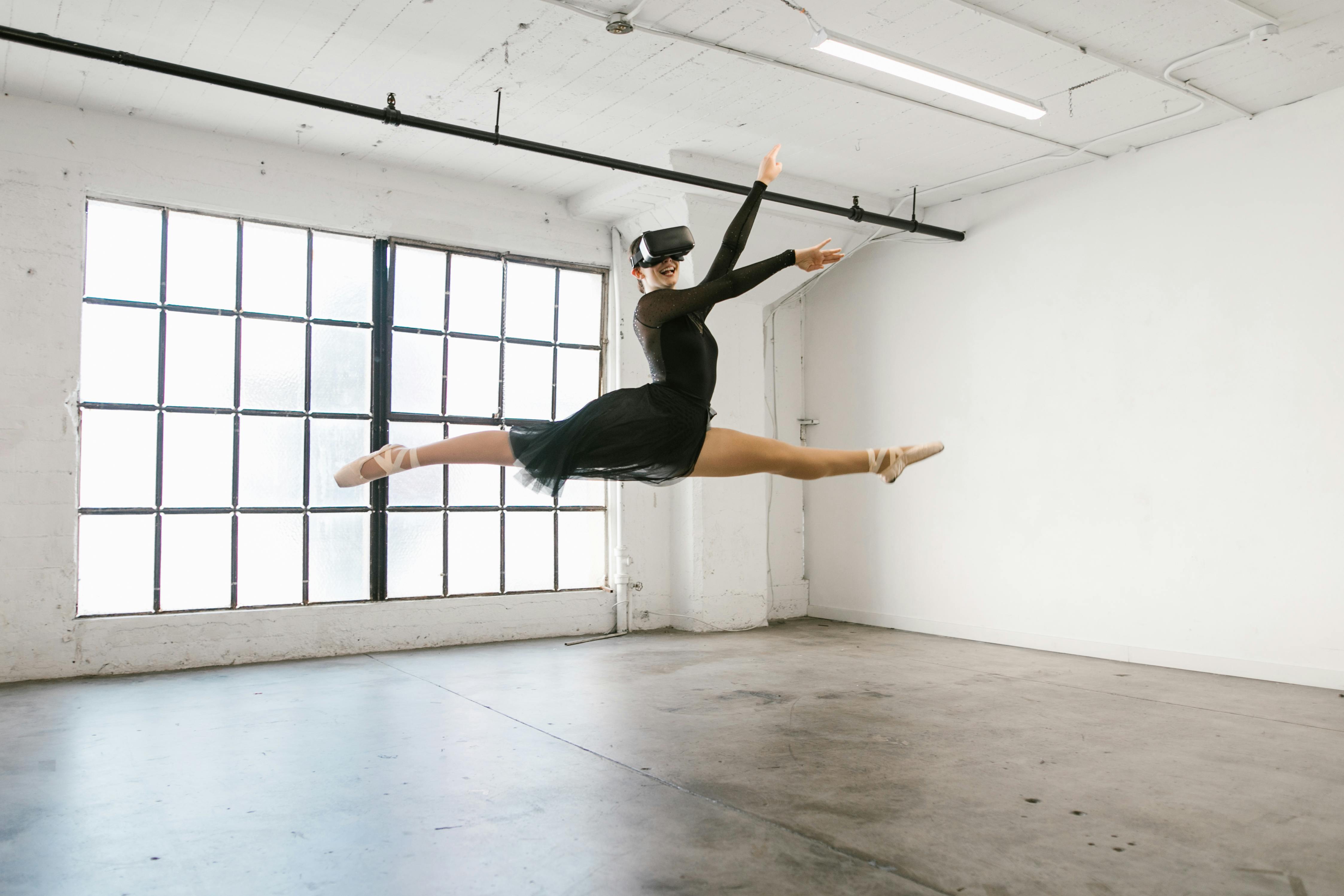 woman dancing while wearing virtual reality glasses