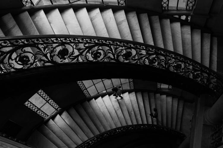 People Going Up On A Spiral Staircase 