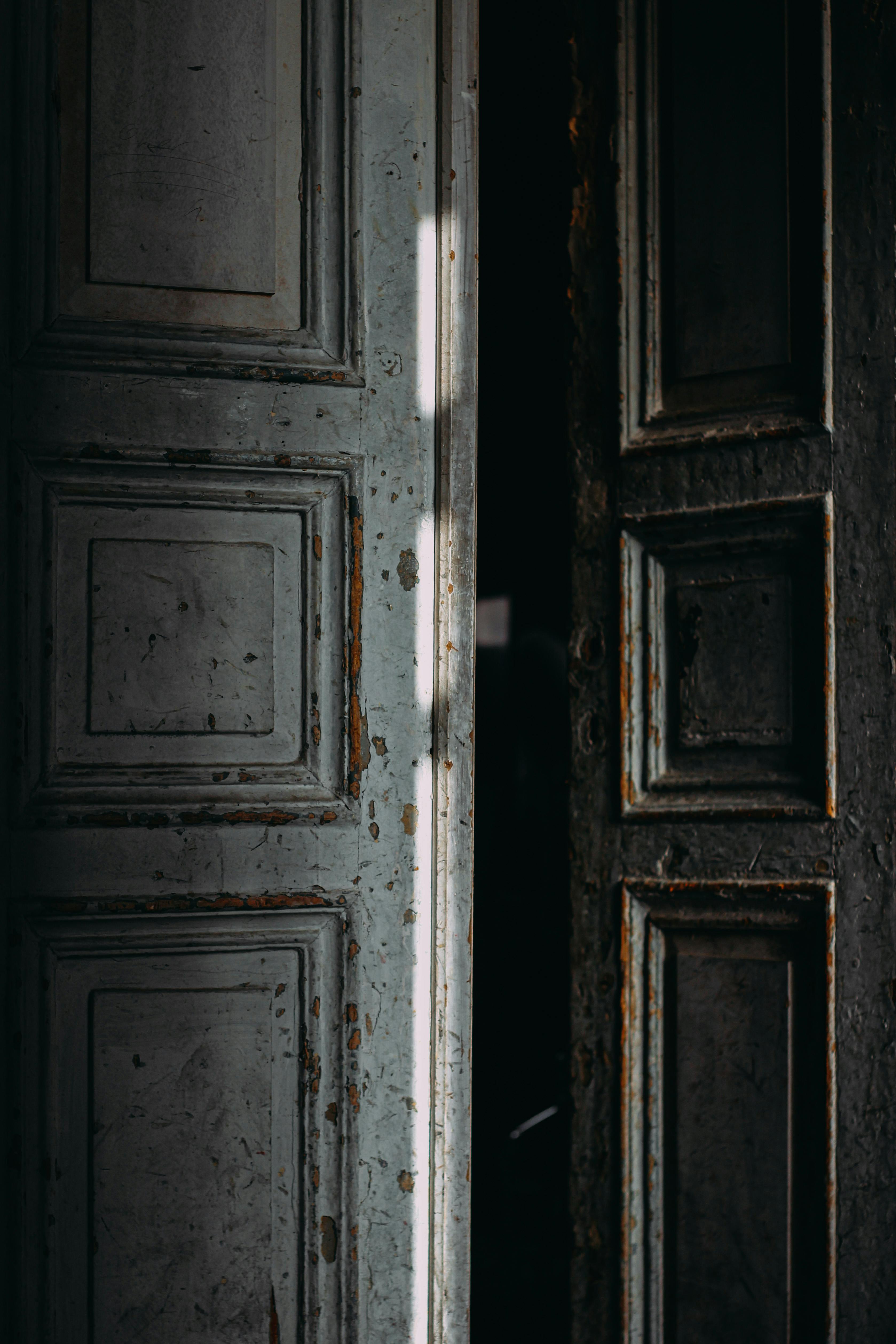 ajar door of shabby building