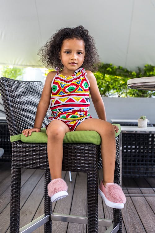 Cute Girl siting on a High Chair