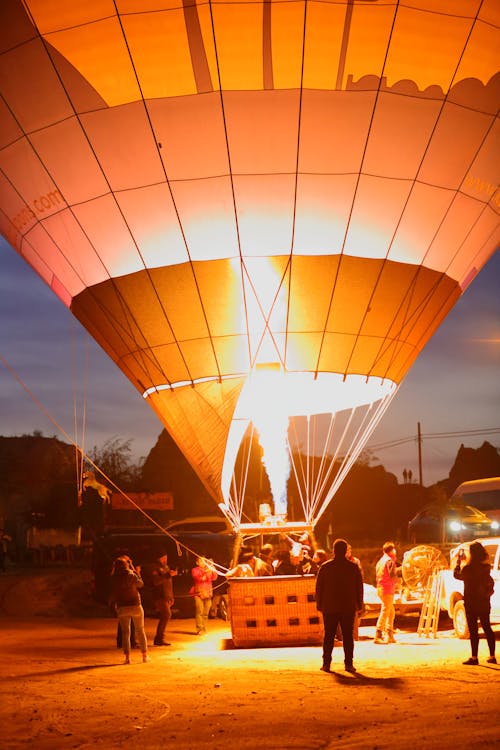 Free People Standing Near the Hot Air Balloon during Night Time Stock Photo
