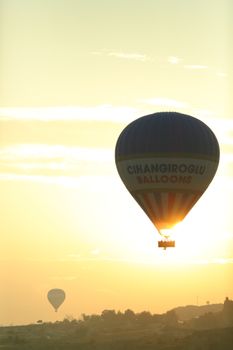 Enchanting view of a hot air balloon gracefully floating during sunrise.