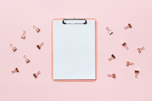 A Clipboard on Pink Background