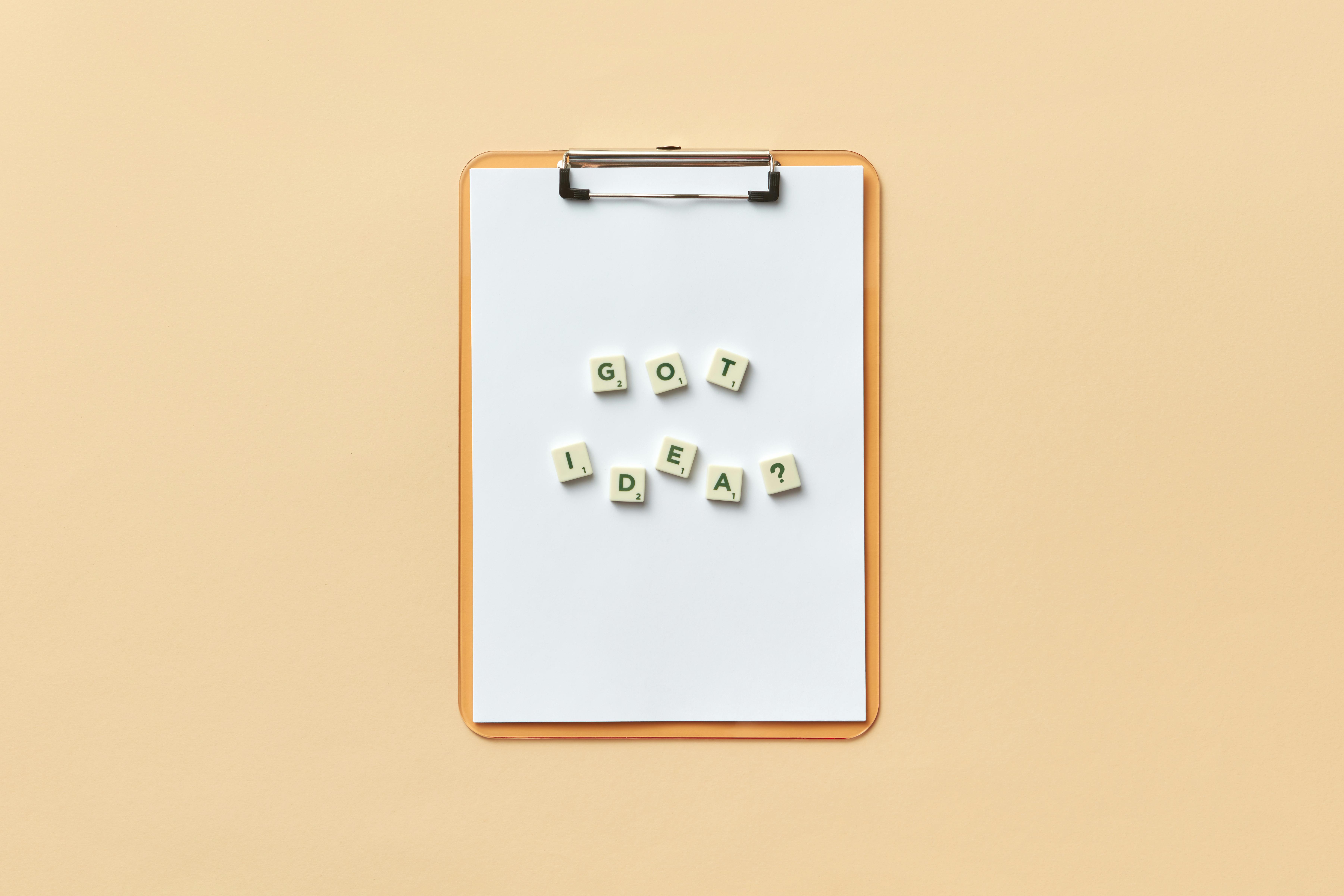 Clipboard with 'Got Idea?' spelled with letter tiles on neutral background.