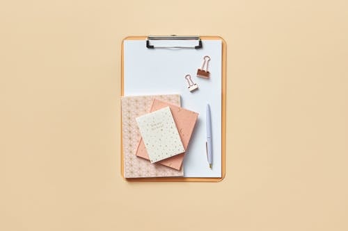 Free Notebooks and Pen on a Clipboard  Stock Photo