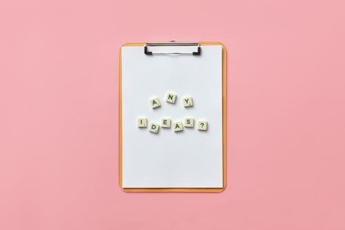 Scrabble Tiles On Clipboard With White Paper