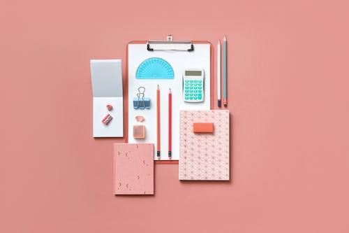 Free School and Office Supplies on a Pink Surface Stock Photo