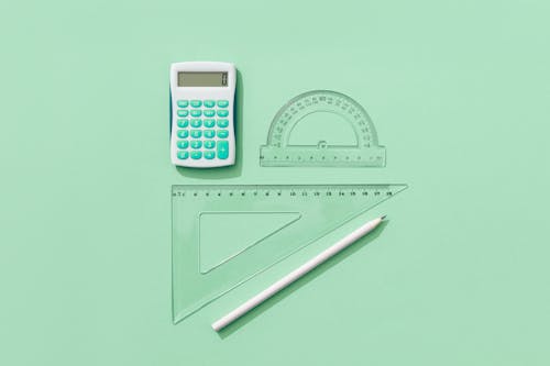 Free Variety of School Supplies On Green Background Stock Photo