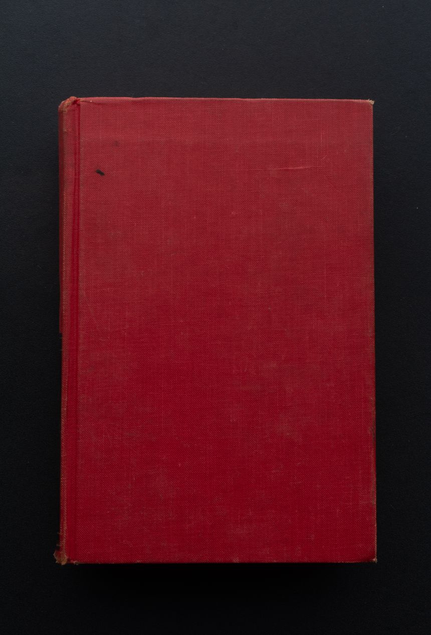 Plain red hardcover book photographed against a dark background, photo by Namukolo Siyumbwa on Pexels