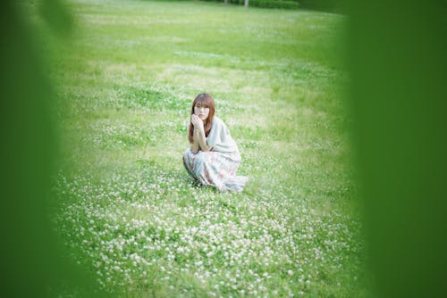Beautiful Woman Sitting on a Flower Field 