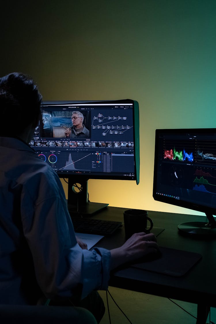 Backview Of An Editor Working On A Computer 