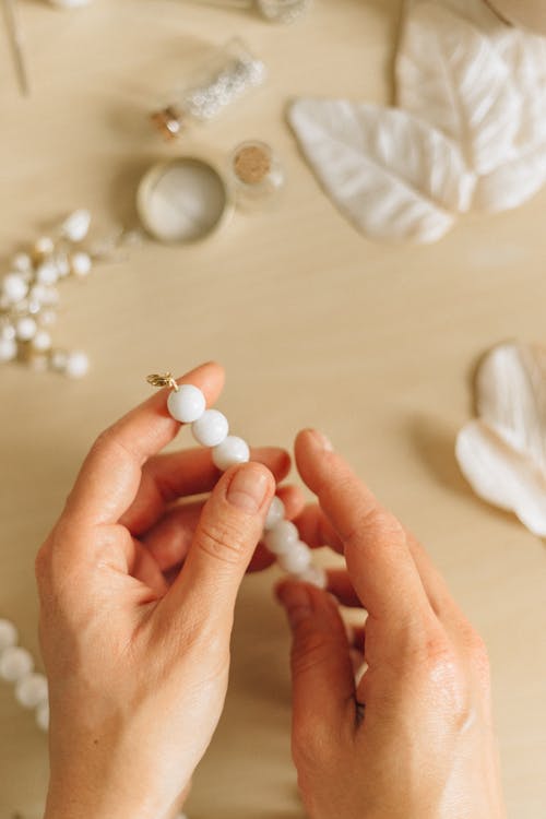Free Person Holding White Pearl Beads Stock Photo