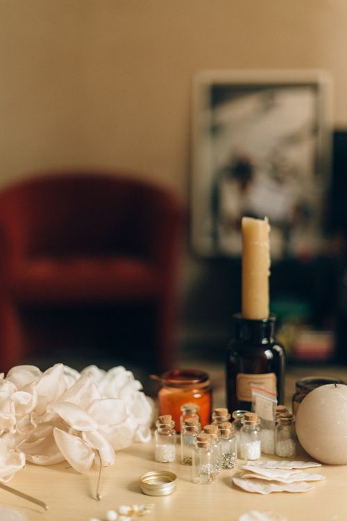 Free Warm still life with candles, bottles, and decorative elements in an indoor setting. Perfect for home decor themes. Stock Photo