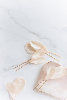 Delicate floral hairpins elegantly arranged on a marble surface.