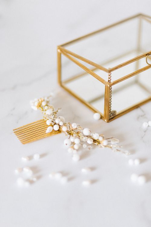 Free Close-up of an elegant bridal hair accessory with pearls beside a decorative box on a marble surface. Stock Photo