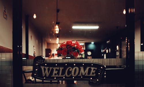 Black Welcome Signage Under Pendant Lamp Photography