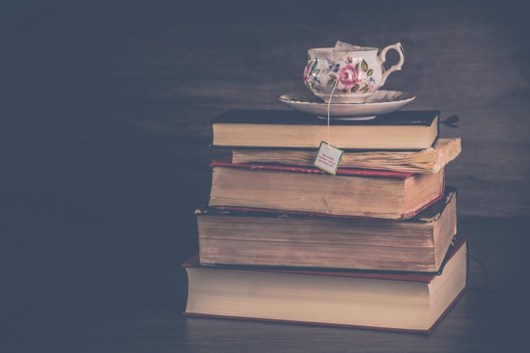 Teacup Placed On Stack Of Hardbound Books