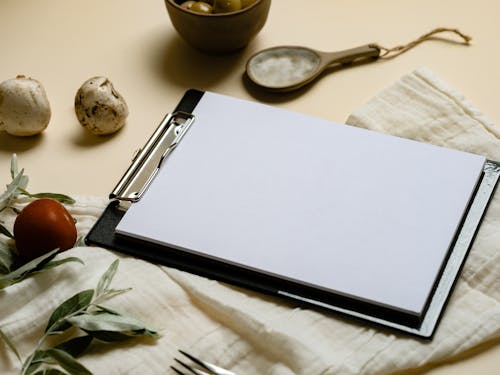 Close Up Photo of Blank Paper on Clipboard
