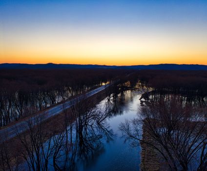 Enchanting aerial view of Trevino, WI, showcasing a serene twilight landscape with leafless trees.