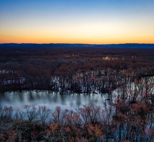 Free Stunning aerial view of a twilight landscape in Trevino, Wisconsin, featuring a forest and river. Stock Photo