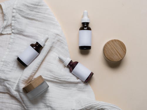 White and Brown Bottles on White Textile