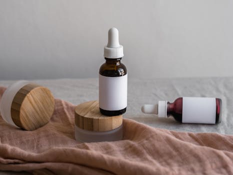 Minimalist setup of skincare bottles with bamboo lids on a textile surface.