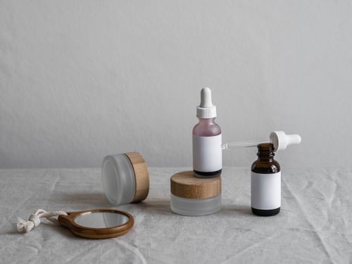 Amber glass serum bottles with droppers on a soft neutral backdrop