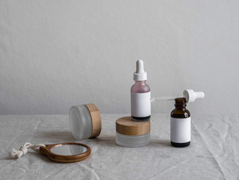 Amber glass serum bottles with droppers on a soft neutral backdrop