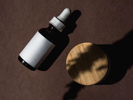 Flat lay of skincare products on a brown surface, showcasing a clean and minimalist design.