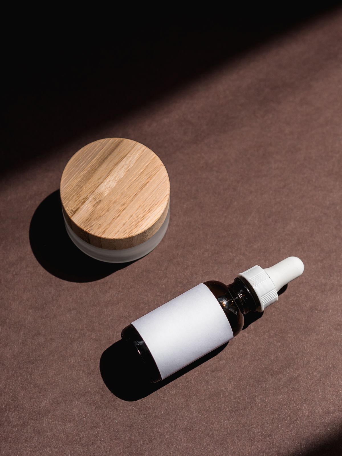 A night cream jar on a bedside surface in low light