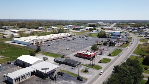 Buildings Near a Parking Lot Under Blue Sky 