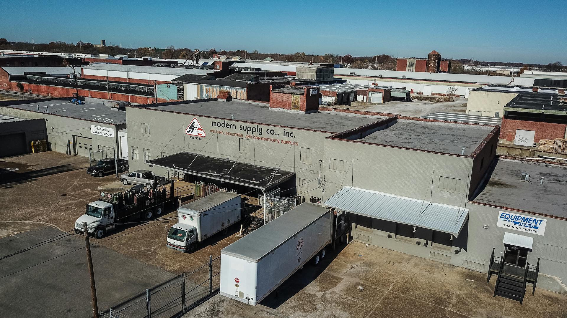 An aerial shot of an industrial warehouse with delivery trucks in Evansville, Indiana.