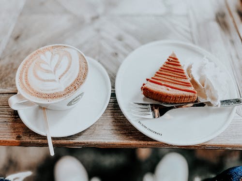 Sliced Cake on White Ceramic Plate Beside a Cup of Coffee