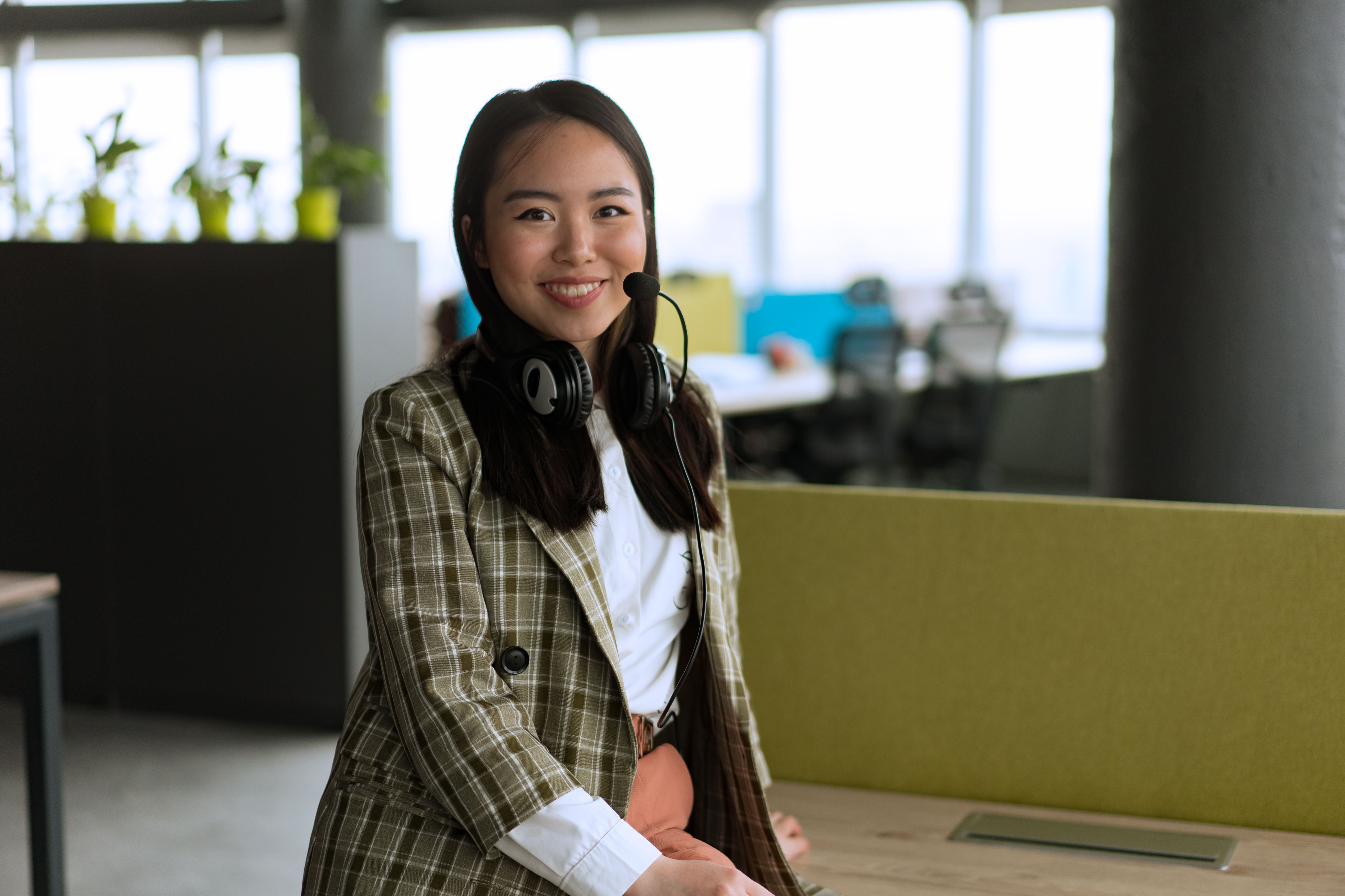 Professional wearing headphones while working at computer