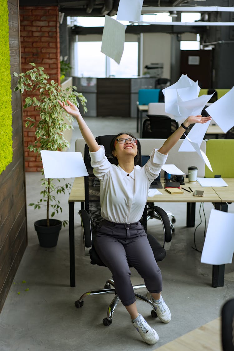 Happy Woman Throwing Papers In The Air